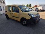 the small yellow van is parked in the parking lot