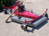 a lawn mower sitting on the ground in the middle of the road