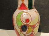 a white vase with a multicolored design on it