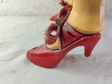 a close up of a red shoe with a cell phone on it
