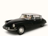 a black toy car with a dog sitting in the passenger seat