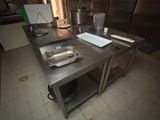 dimly lit kitchen with stainless steel counter tops and stainless steel cabinets