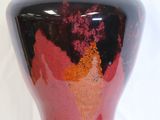 a vase that is sitting on a table with a white background