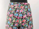 a close up of a woman ' s shorts with flowers on it