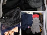 a suitcase filled with clothes and gloves on the floor