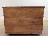 an old wooden chest sitting on top of a hard wood floor
