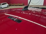 a close up of a red car with a sticker on it