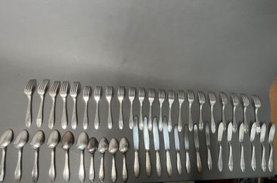 a lot of forks and spoons that are on the table