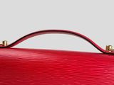 a red louis vuitton bag on a white background