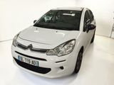a small white car parked in a white room
