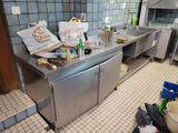 a kitchen with a lot of clutter on the counter