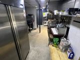 a kitchen with stainless steel appliances and a wooden counter