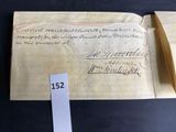 an old book with a piece of paper on top of it