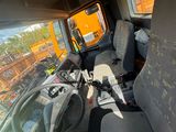 a view of the inside of a truck from the driver ' s seat
