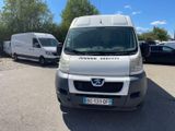 a white van parked in a parking lot next to other cars