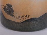 a close up of a vase with a tree on it