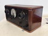 an old radio sitting on top of a table next to a laptop