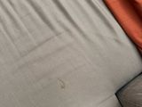 a person laying on a bed with a pillow on it