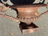 a vase that is sitting on the ground with a shadow on it