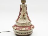 a red and white vase with a light on it