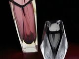 two vases sitting on a table next to each other