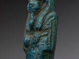 an egyptian statue of a woman holding a baby in her arms