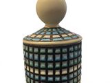 a small jar with a lid that has a pattern on it