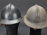 pair of silver and black fire helmets sitting on top of each other
