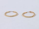 a pair of gold hoop earrings on a white background
