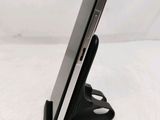 a close up of a cell phone on a stand on a table