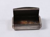an image of a small silver box on a white surface