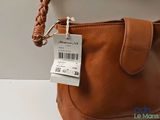 a brown purse with a price tag on it
