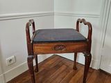 a small wooden bench in a corner of a room