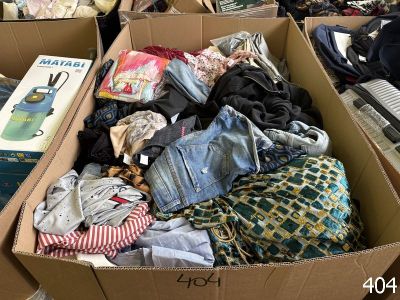 a cardboard box filled with clothes and other items