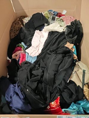 a cardboard box filled with clothes and other items