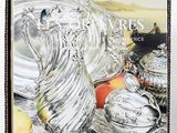 a book that has a picture of a silver vase on it
