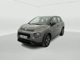a grey citrole is parked in a white room
