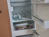 an open refrigerator with the door open in a kitchen