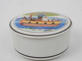 a small white box with a picture of a boat on it