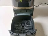 a gray and black air fryer sitting on a counter