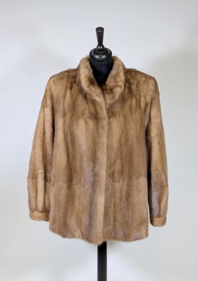 a close up of a fur coat on a mannequin stand
