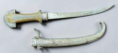 pair of antique silverware knifes on a white surface