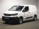 the white van is parked in a large room with a checkered floor