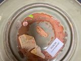 a green vase with a tag on it