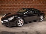 a picture of a black sports car parked in a garage