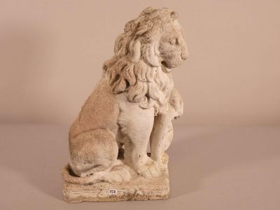 a stone statue of a lion sitting on a stone block