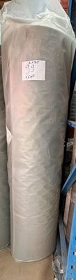 two large rolls of fabric sitting on a pallet in a warehouse