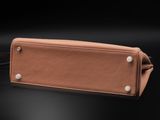 a brown leather purse with white buttons on the side