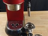 an image of a red coffee maker on a wooden table