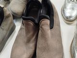 several pairs of shoes are lined up on a white surface